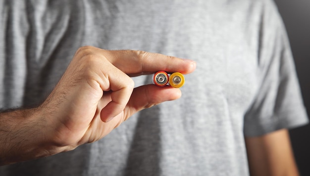 Male hand showing alkaline batteries