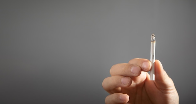 Male hand showing cigarette Concept of smoking