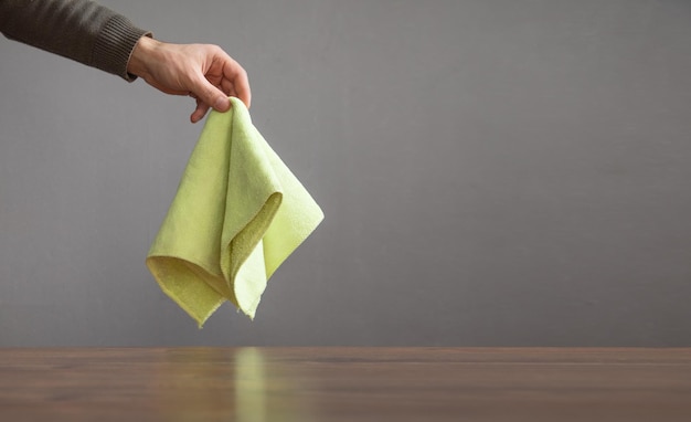 Male hand showing rag on the table