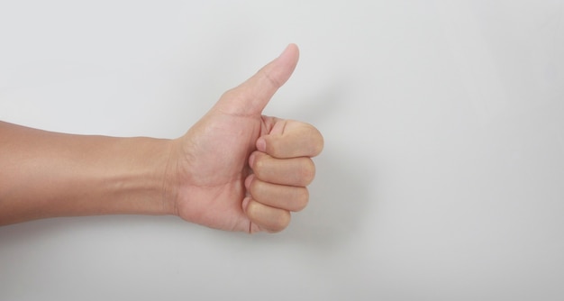 Male hand showing thumbs up sign against