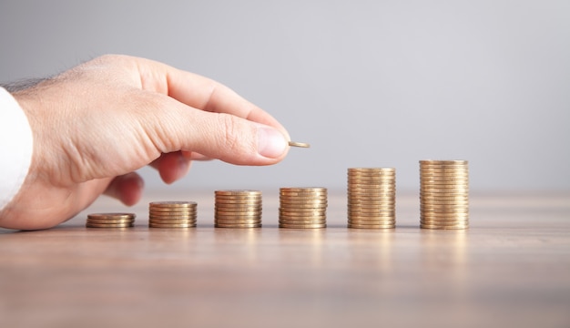 Male hand stacking coins. Saving money. Business. Investment