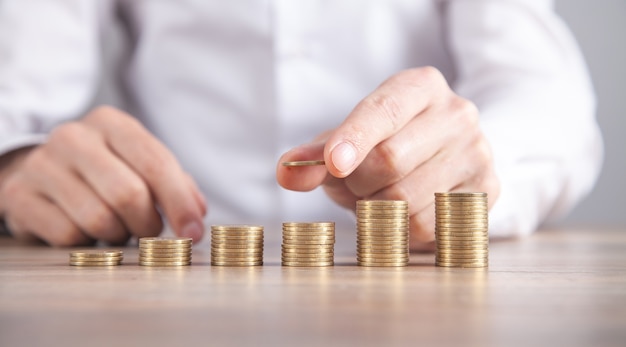 Male hand stacking coins. Saving money. Business. Investment