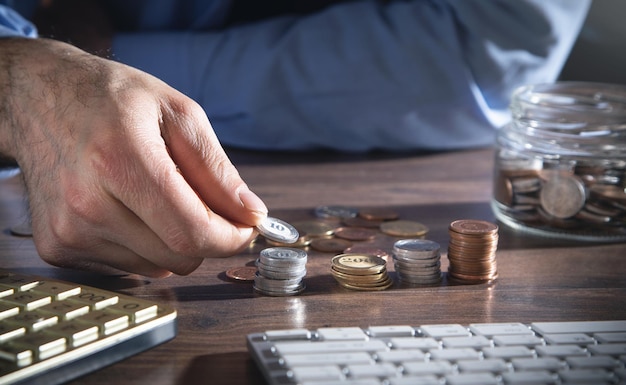 Male hand stacking coins. Saving money