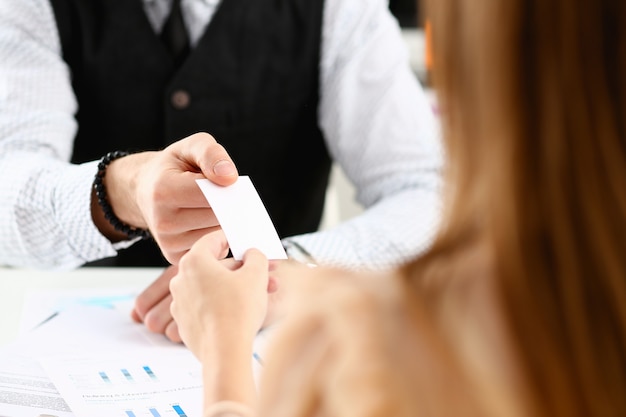 Male hand in suit give blank calling card to visitor