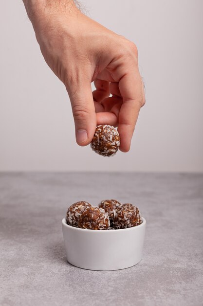 Male hand takes raw food candy