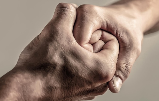 Mano maschile unita nella stretta di mano l'uomo aiuta la protezione della tutela delle mani amici amichevoli della stretta di mano che salutano salvataggio che aiuta la mano