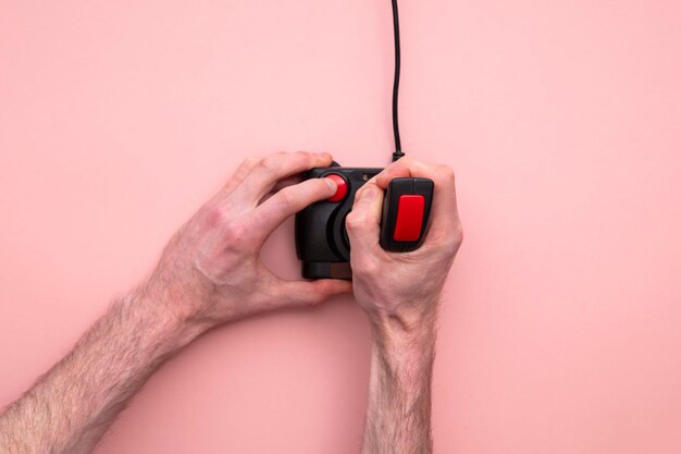 Male hand using retro video game joystick controller overhead view