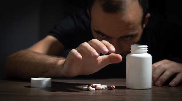 Male hand with a bottle of medical pills