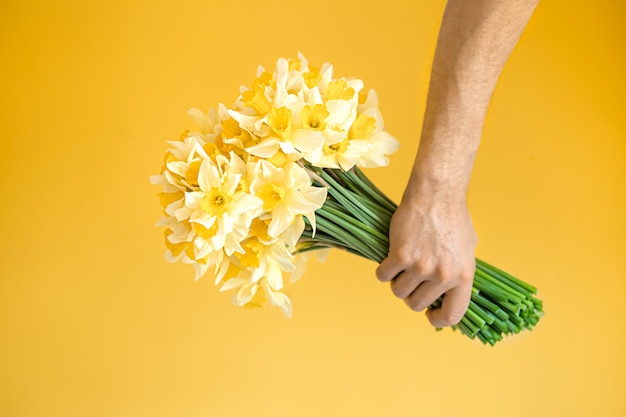 Male hand with a bouquet of flowers