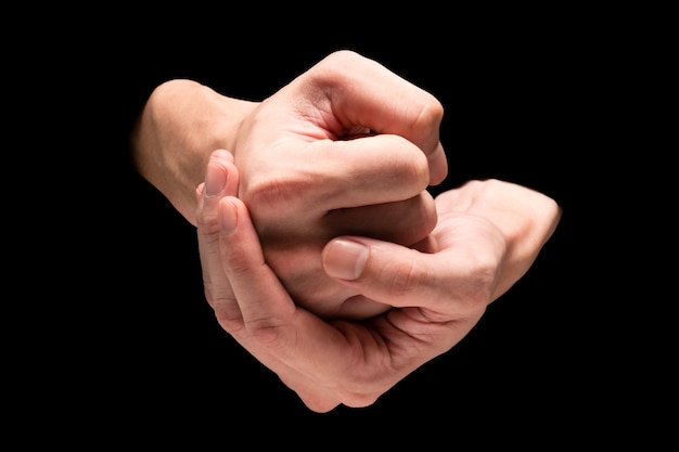 Male hands on a black background.