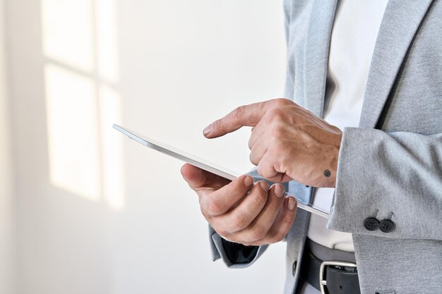 Male hands businessman using digital tablet technology corporate fintech