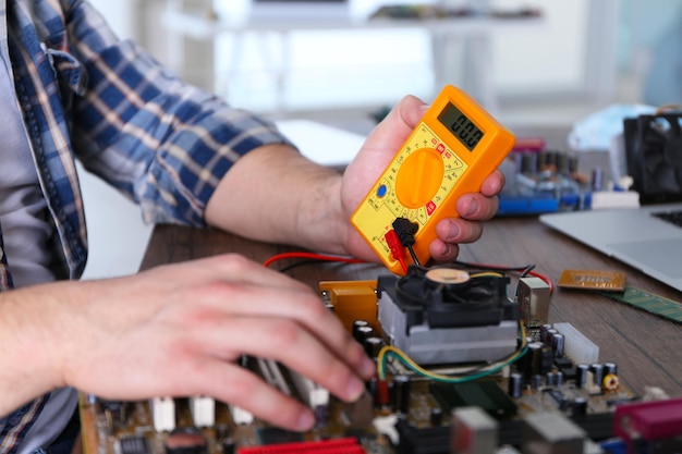 Male hands checking electronic hardware in service center