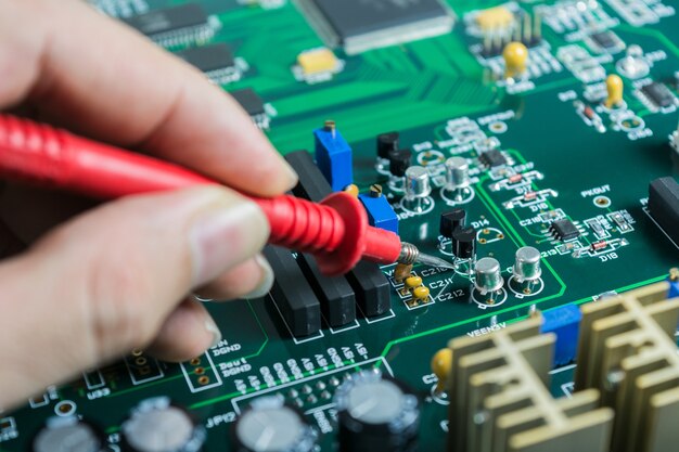 Male hands close up checking voltage on transistor