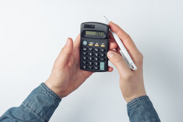 Male hands count on a calculator