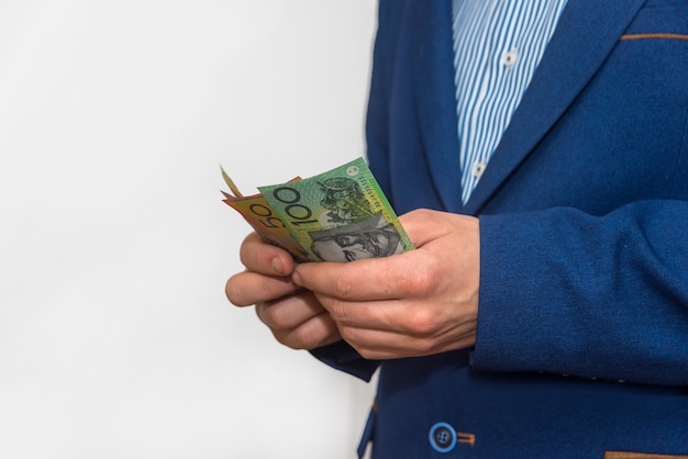 Male hands counting australian dollar banknotes, macro