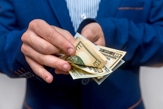 Male hands counting dollar banknotes close up