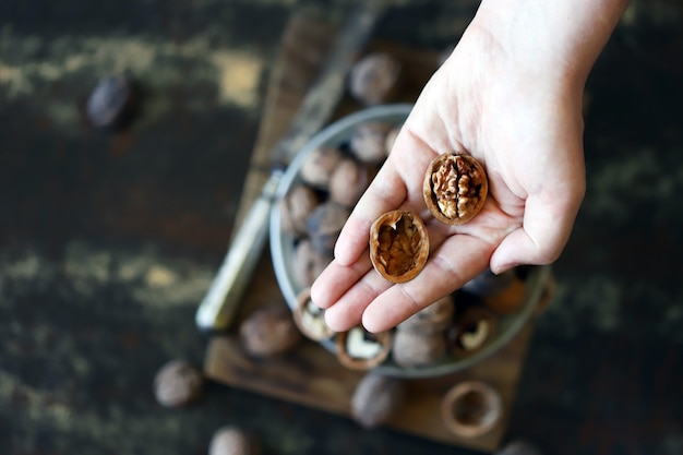 Male hands extract a walnut from the shell