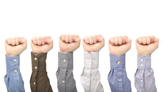 Male hands in fists in different shirts isolated. Protest and indignation.