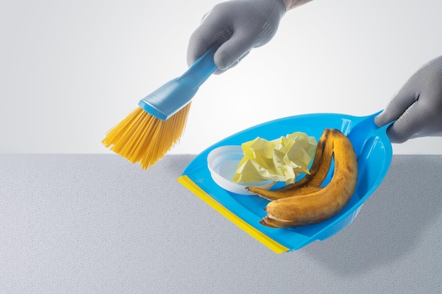 Male Hands In Gloves Sweeping Dust With A Broom Cleaning Housekeeping Concept