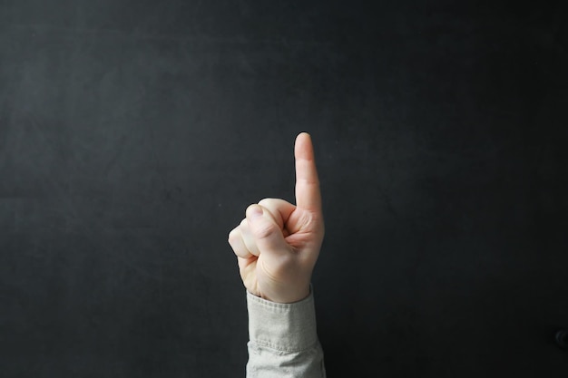 Photo male hands on a gray background finger gestures gesticulation with hands