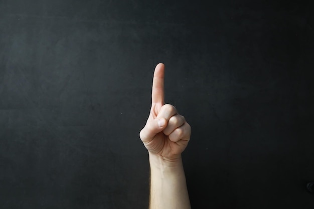 Male hands on a gray background Finger gestures Gesticulation with hands