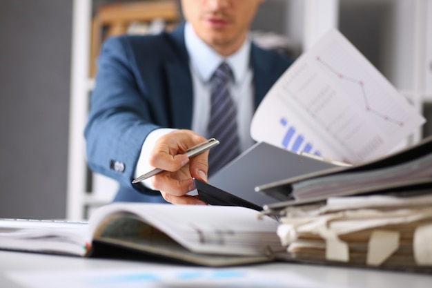 Male hands hold documents with financial statistics