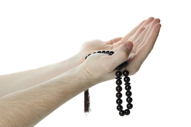 Male hands hold prayer beads, isolated on white