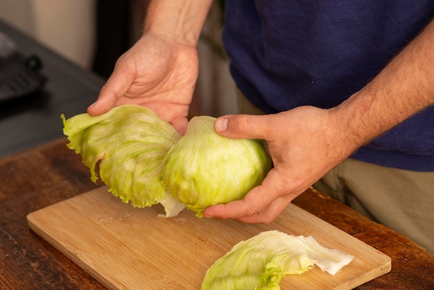 Male hands holding a head of lettuce