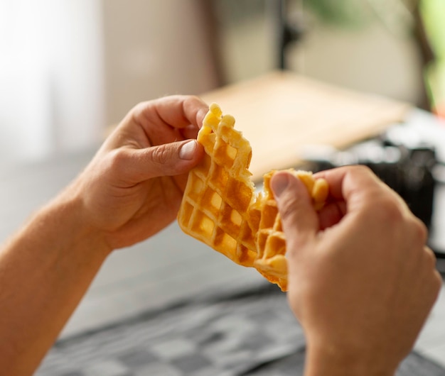 male hands holding homemade waffles