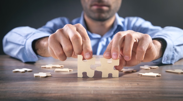 Male hands holding a jigsaw puzzle.