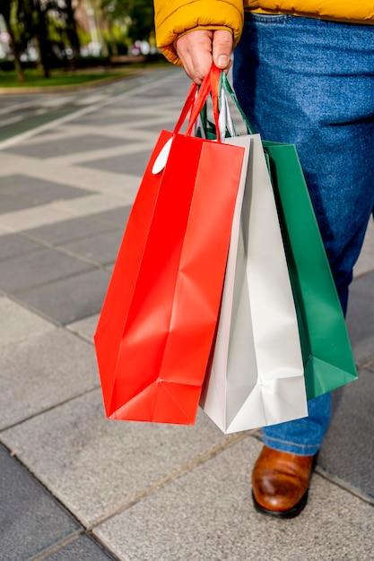 Male hands holding shopping bags