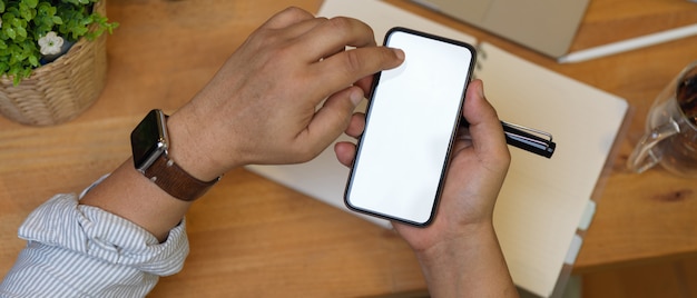 Male hands holding smartphone with white screen