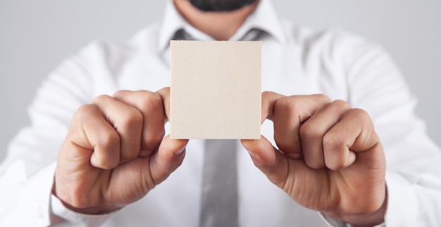 Male hands holding wooden empty board for your text