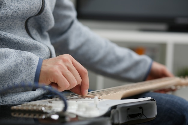 Male hands at home play and tun