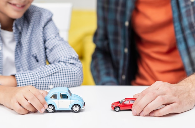 Male hands playing with toy cars