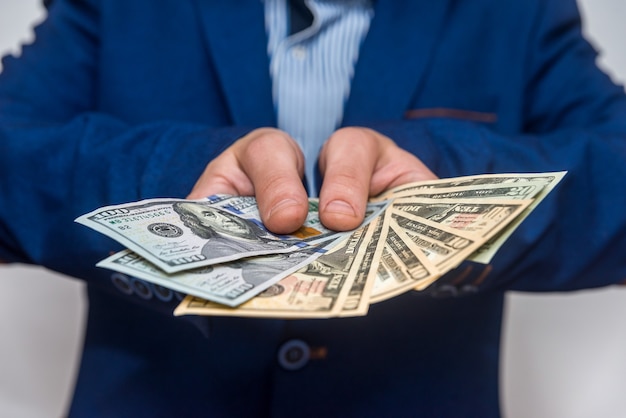 Male hands showing dollar banknotes close up