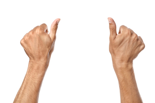 Male hands showing thumb-up gesture on white surface