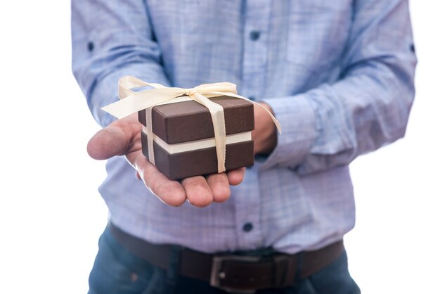 Male hands with gift box isolated