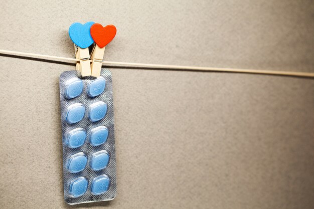 Male health pills hang on a rope