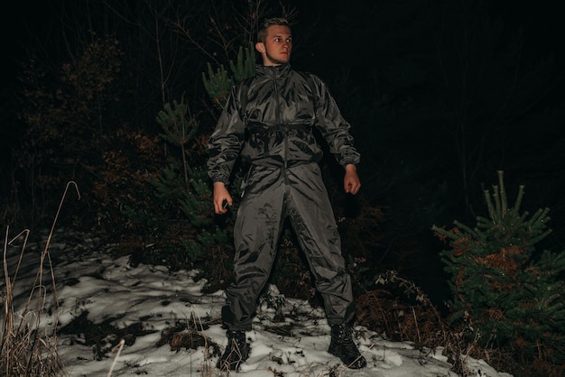 Male hikers in clothes for hiking and flashlights on winter mountain at night