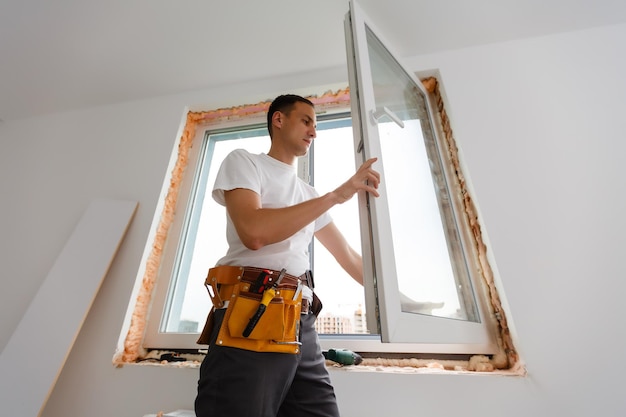 male industrial builder worker at window installation in building construction site