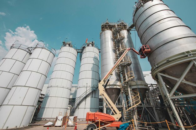 Male industry working at high in a boom liftinspection tank silo