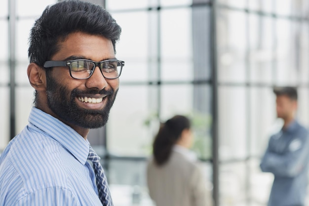 male investor beard looking at camera and smiling in modern office