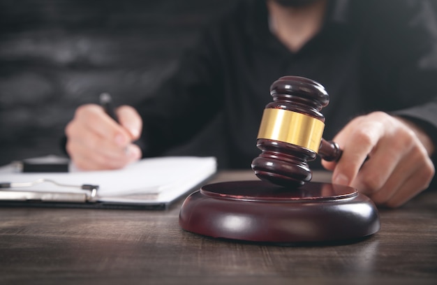 Male judge in a courtroom striking the gavel.