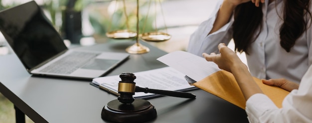 Male lawyer working with contract papers and wooden gavel on tabel in courtroom justice and law attorney court judge concept