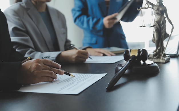 Male lawyer working with contract papers and wooden gavel on tabel in courtroom justice and law attorney court judge concept