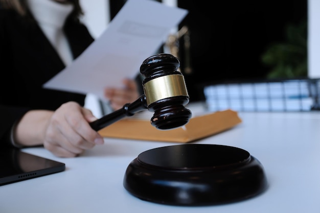 Male lawyer working with contract papers and wooden gavel on tabel in courtroom justice and law attorney court judge concept