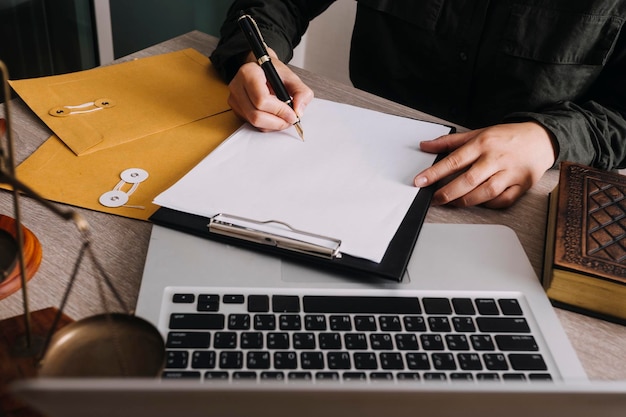 Male lawyer working with contract papers and wooden gavel on tabel in courtroom justice and law attorney court judge concept