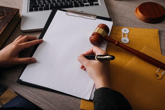 Male lawyer working with contract papers and wooden gavel on tabel in courtroom justice and law attorney court judge concept