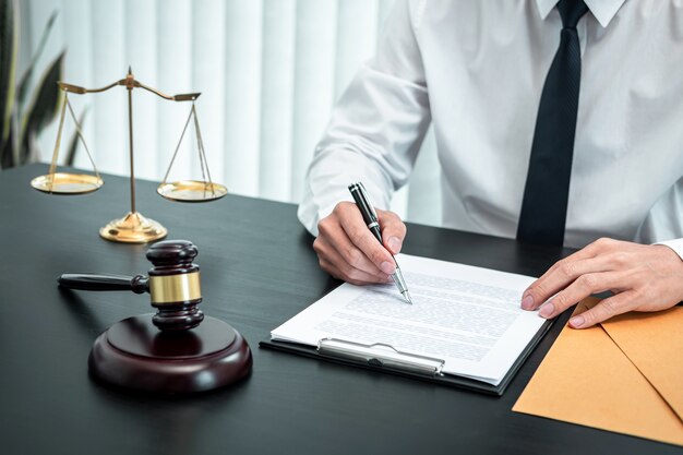 Male lawyer working with legal case document contract in office, law and justice, attorney, lawsuit concept.